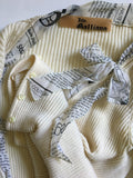 John Galliano Ivory Ribbed Knit Cardigan with Pearlescent Buttons and Newsprint Ribbons - BOUTIQUE PURCHASE PRICE